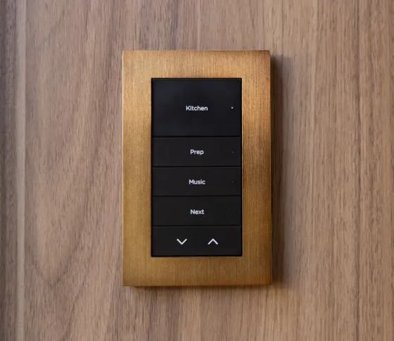 Control4 LUX keypad with a bronze faceplate and engraved scene buttons